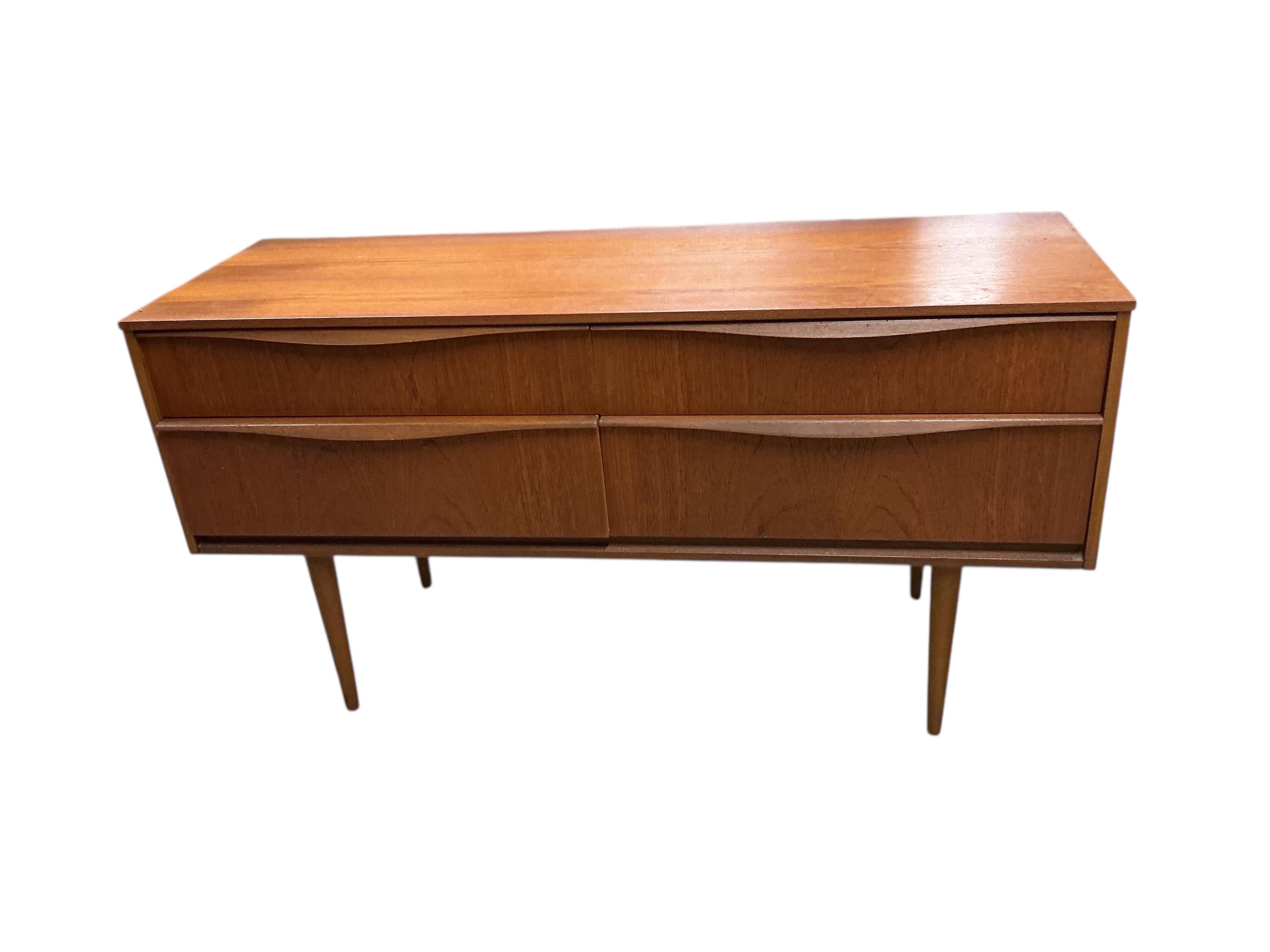 A mid century teak four drawer chest, width 124cm, depth 42cm, height 66cm